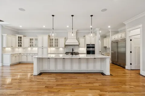 a kitchen with sink stove and refrigerator