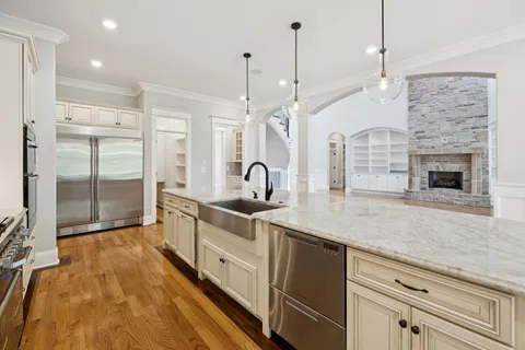 a bathroom with a granite countertop toilet sink and mirror