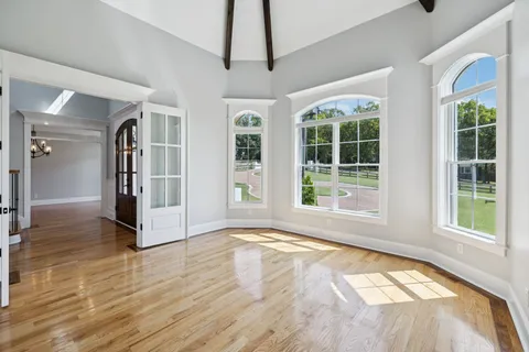 a bathroom with a granite countertop sink vanity mirror and toilet