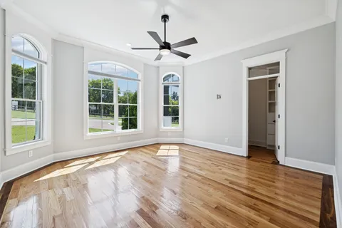 a view of an empty room with a fireplace and a large window