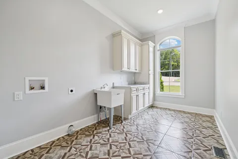 a view of a house with a yard and table and chairs under an umbrella