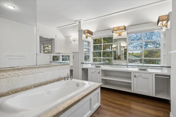 a spacious bathroom with a tub shower and sink