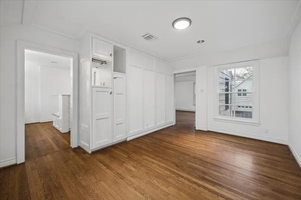 a view of an empty room with a fireplace and a window