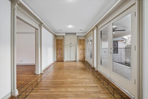 a view of a hallway with wooden floor