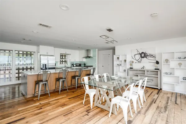 a view of a dining room with furniture and wooden floor