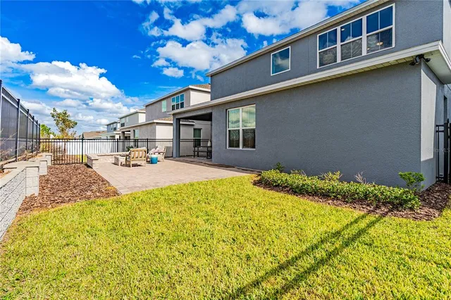 a dining room with furniture a chandelier and kitchen view