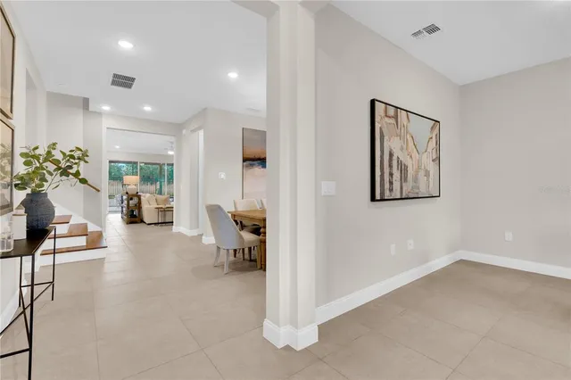 a view of a dining room with furniture and a chandelier