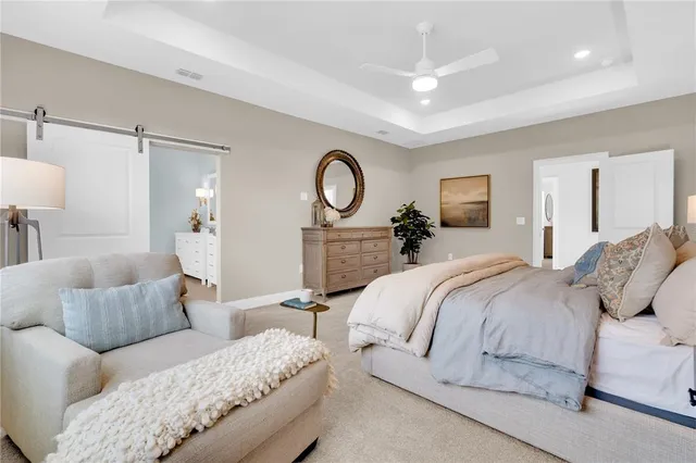 a bedroom with a bed and painting on the wall