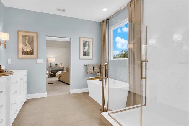 a bedroom with a bed and a flat tv screen on a dresser