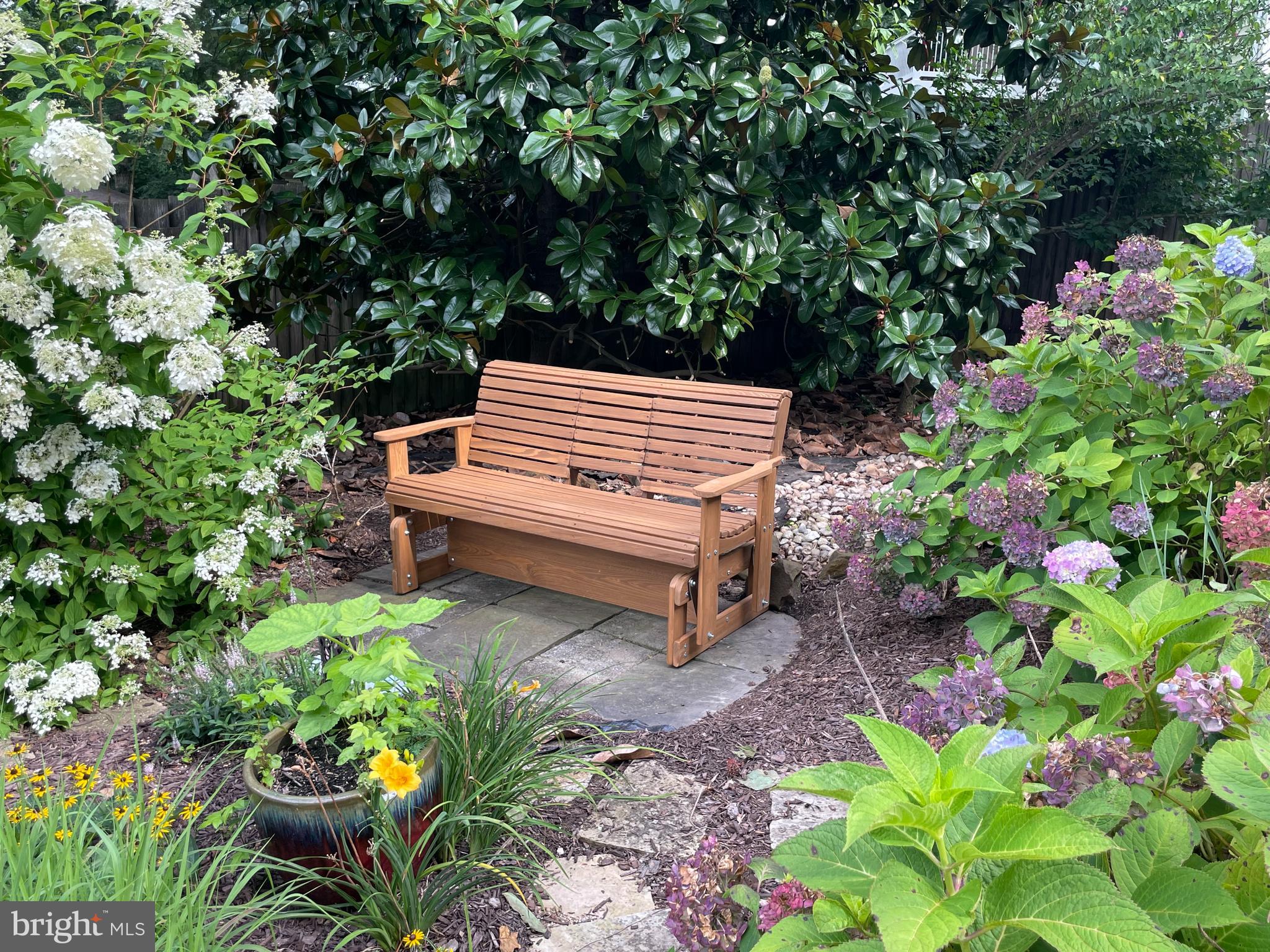 3325 Glebe Drive Edgewater, MD 21037 - Photo 57 of 84 a backyard with potted plants and a tree