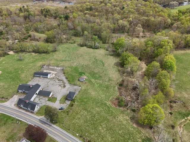 an aerial view of a house with a yard