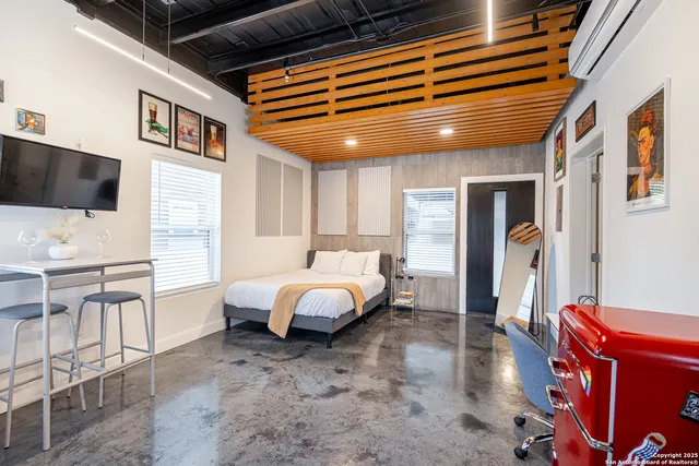 a spacious bedroom with a bed and a desk