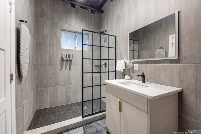 a bathroom with a sink a toilet and shower