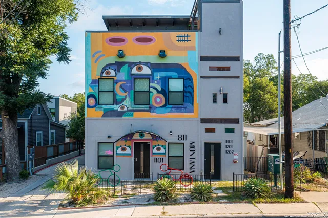 a front view of multi story residential apartment building with yard