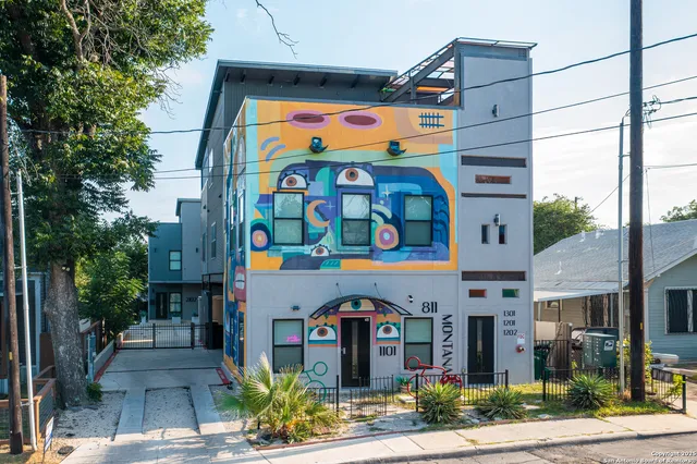 an aerial view of residential house with outdoor space and trees all around