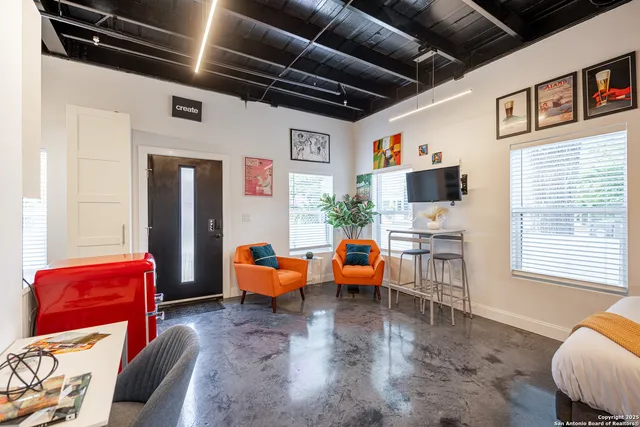 a living room with furniture and a flat screen tv
