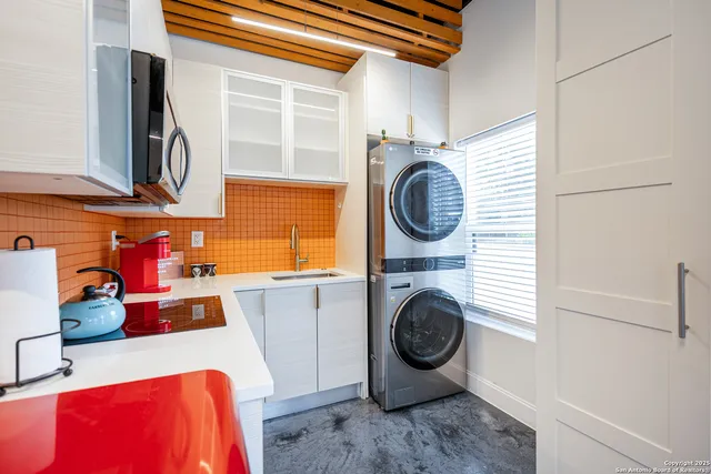 a utility room with sink dryer and washer