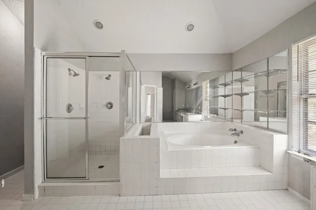a bathroom with a bathtub and shower