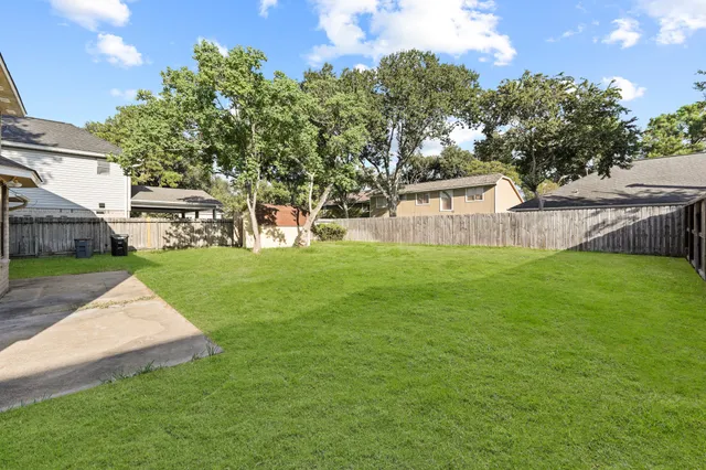 a view of a house with a yard and sitting area