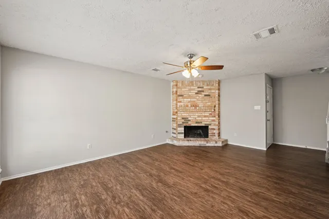 a view of a livingroom with a fireplace and window