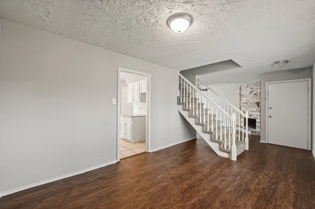 a view of a hallway with wooden floor and entryway