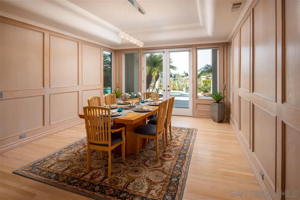 7430 St Andrews Road Rancho Santa Fe, CA 92067 - Photo 12 of 25 a dining room with furniture a rug and wooden floor
