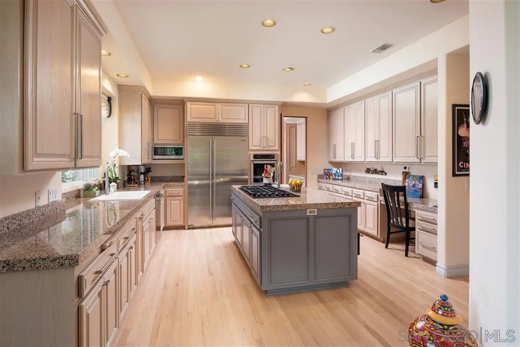 7430 St Andrews Road Rancho Santa Fe, CA 92067 - Photo 14 of 25 a large kitchen with stainless steel appliances a lot of counter space and a wooden floors