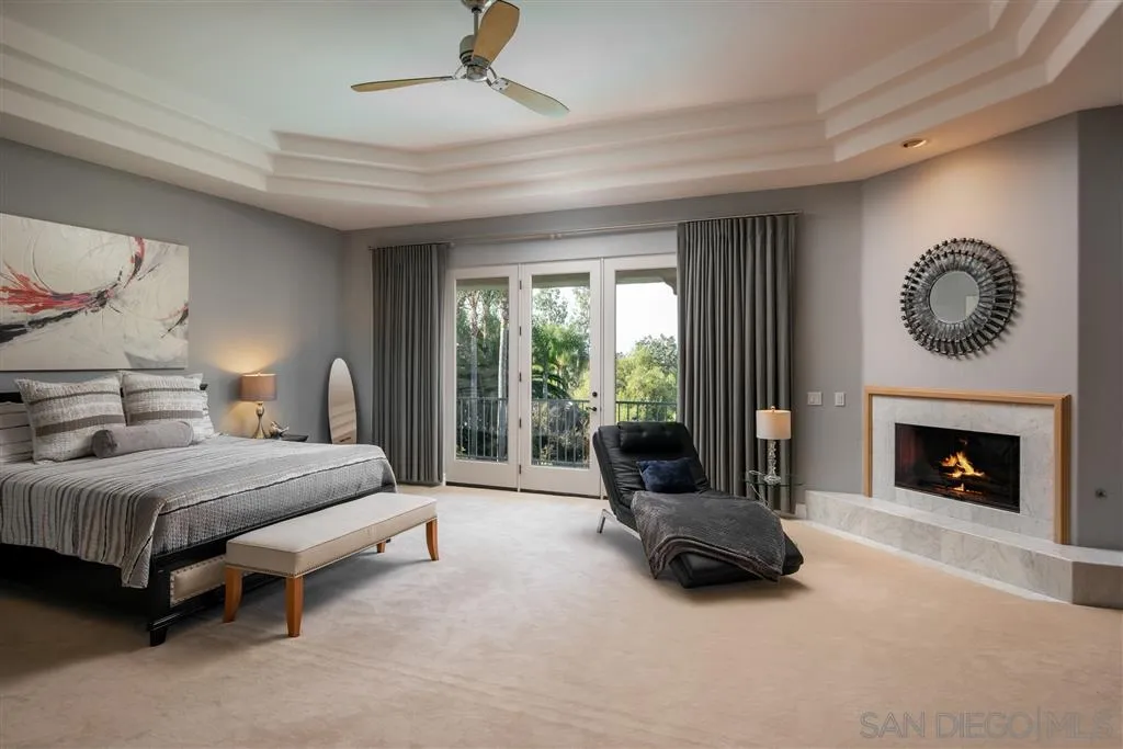 7430 St Andrews Road Rancho Santa Fe, CA 92067 - Photo 19 of 25 a spacious bedroom with a bed and a fireplace