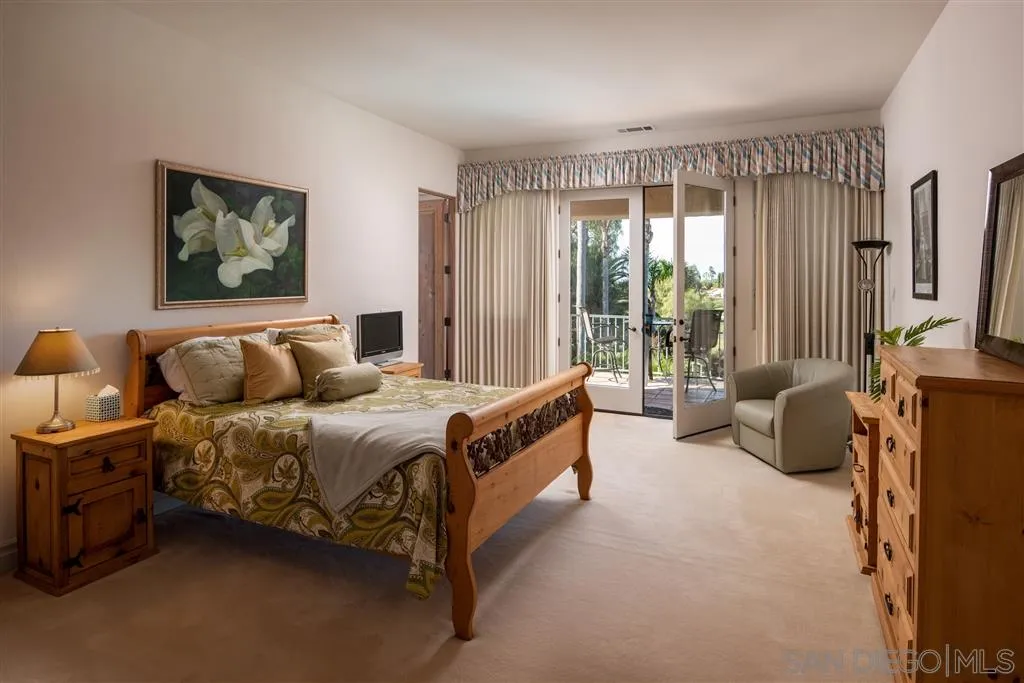 7430 St Andrews Road Rancho Santa Fe, CA 92067 - Photo 22 of 25 a spacious bedroom with a bed and a flat tv screen