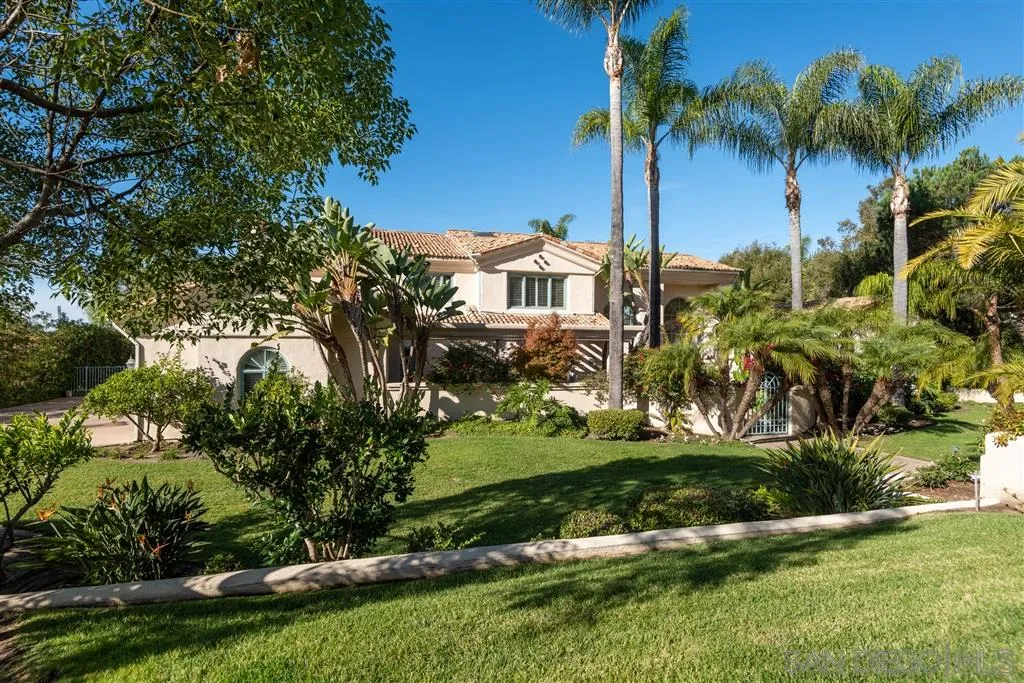 7430 St Andrews Road Rancho Santa Fe, CA 92067 - Photo 6 of 25 a view of a house with a yard and palm trees