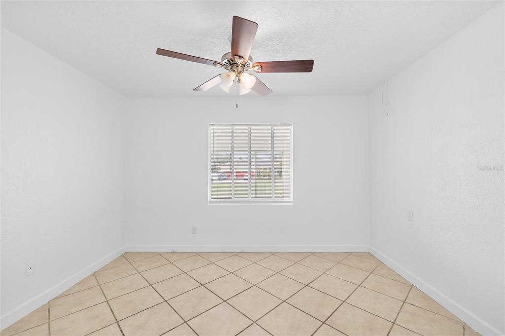 2196 Bell Cheer Drive Clearwater, FL 33764 - Photo 21 of 55 an empty room with windows and fan