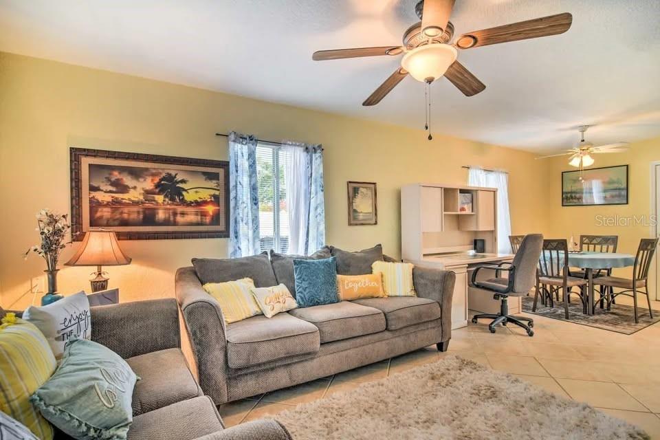 2196 Bell Cheer Drive Clearwater, FL 33764 - Photo 27 of 55 a living room with furniture ceiling fan and a rug