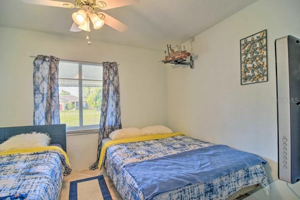 2196 Bell Cheer Drive Clearwater, FL 33764 - Photo 28 of 55 a bedroom with a bed and a chandelier