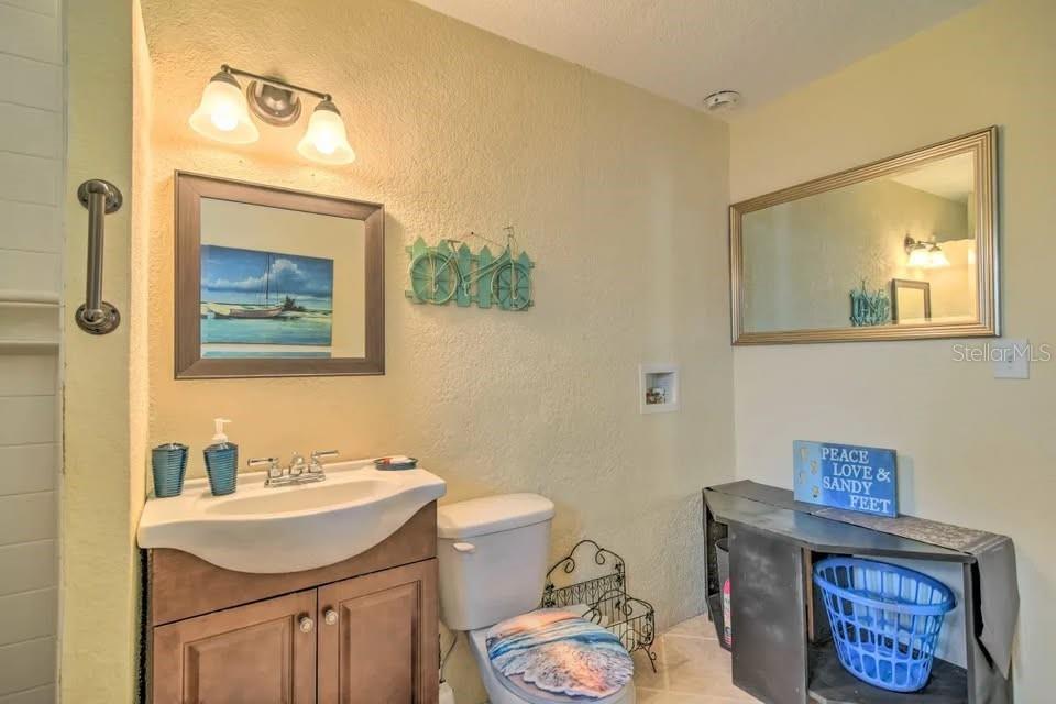 2196 Bell Cheer Drive Clearwater, FL 33764 - Photo 29 of 55 a bathroom with a sink a toilet and mirror
