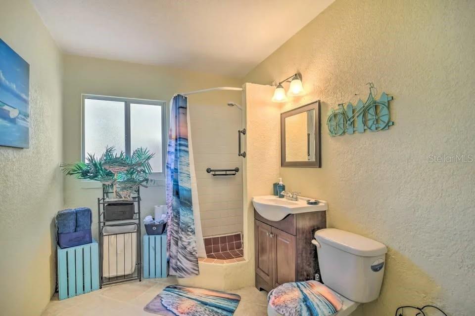 2196 Bell Cheer Drive Clearwater, FL 33764 - Photo 36 of 55 a bathroom with a toilet sink and mirror