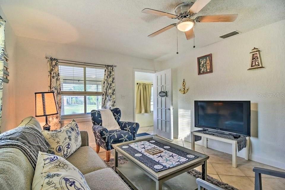 2196 Bell Cheer Drive Clearwater, FL 33764 - Photo 39 of 55 a living room with furniture and a flat screen tv