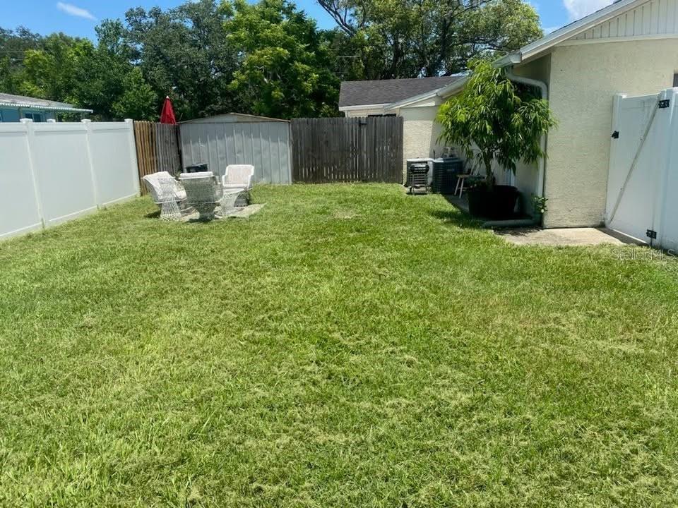 2196 Bell Cheer Drive Clearwater, FL 33764 - Photo 42 of 55 a view of a chair and table in backyard of the house