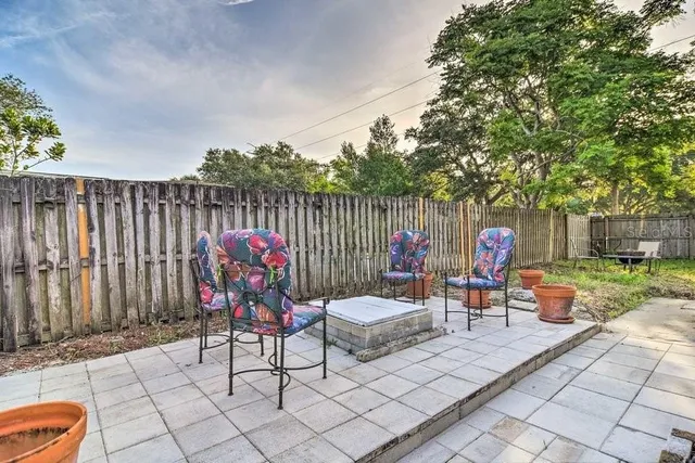 a view of backyard of house with outdoor seating and green space