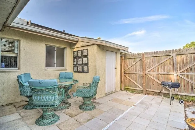 a view of a yard with wooden fence