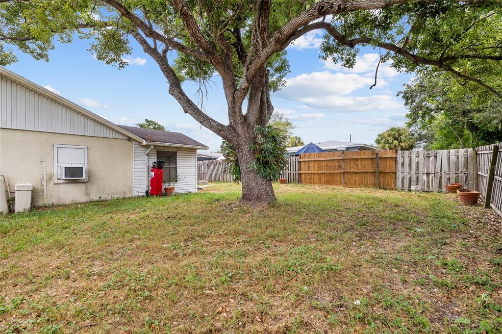 2196 Bell Cheer Drive Clearwater, FL 33764 - Photo 52 of 55 a backyard of a house with table and chairs