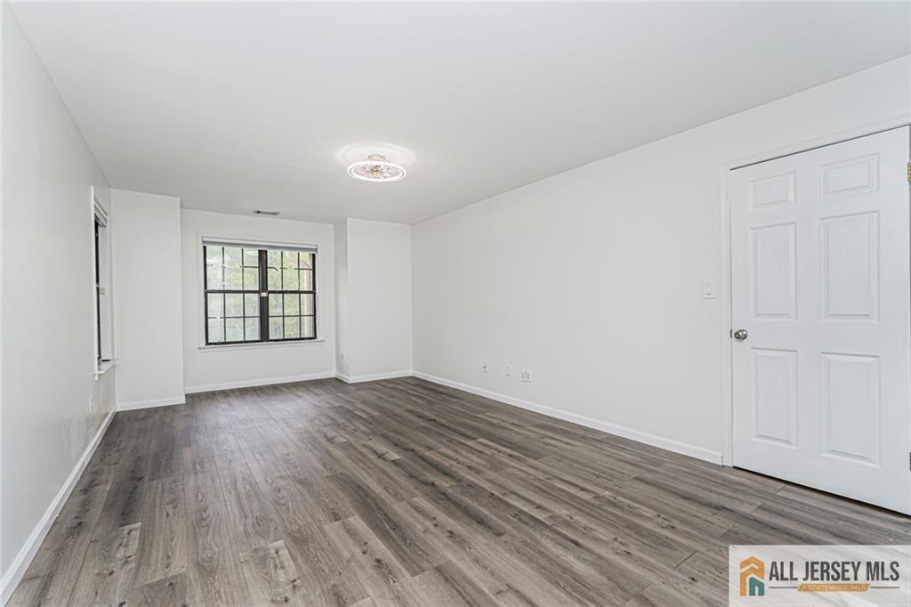 612 Chester Court Helmetta, NJ 08828 - Photo 17 of 31 wooden floor in an empty room with a window