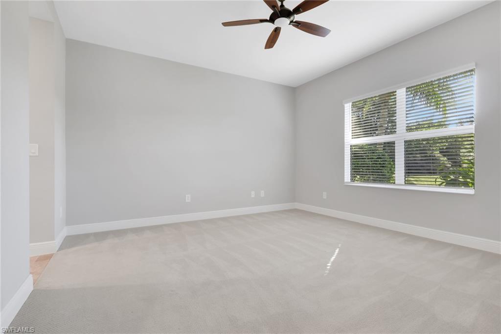 2231 Marquesa Circle Naples, FL 34112 - Photo 14 of 38 a view of a big room with windows and chandelier fan