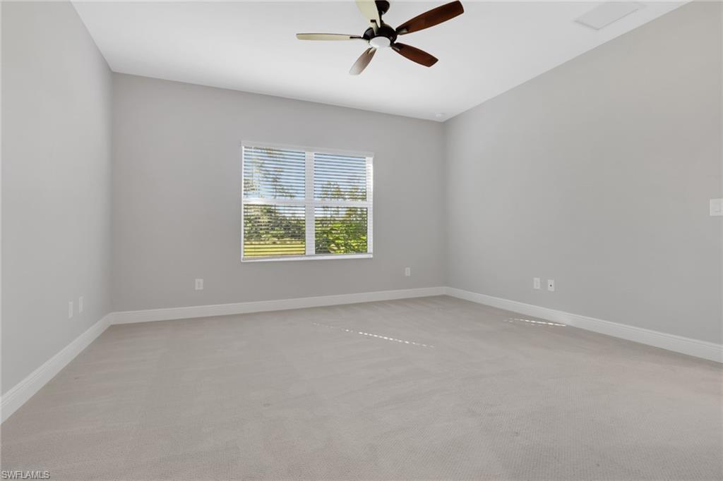 2231 Marquesa Circle Naples, FL 34112 - Photo 15 of 38 an empty room with a window and a fan