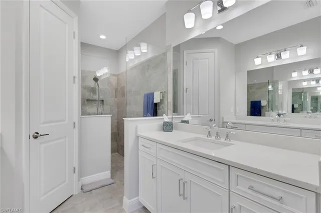 a bathroom with a sink double vanity and a mirror
