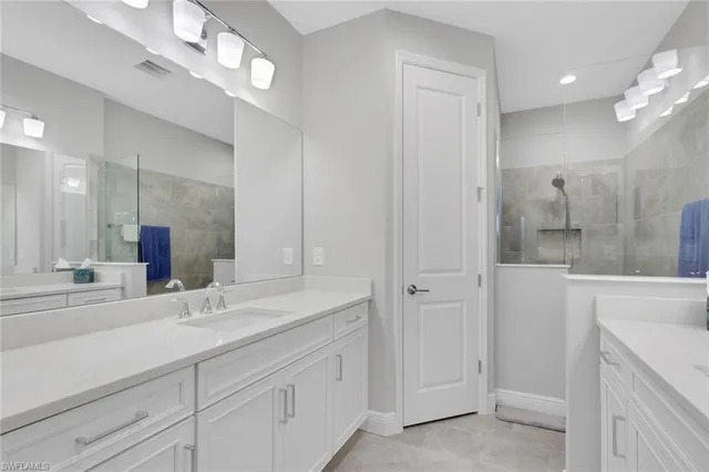 a bathroom with a double vanity sink and a mirror