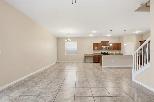 a view of kitchen with kitchen island granite countertop a stove top oven and cabinets