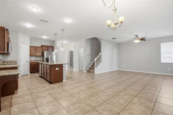 a view of kitchen with furniture and refrigerator