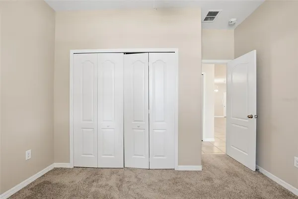 a view of an empty room with closet area