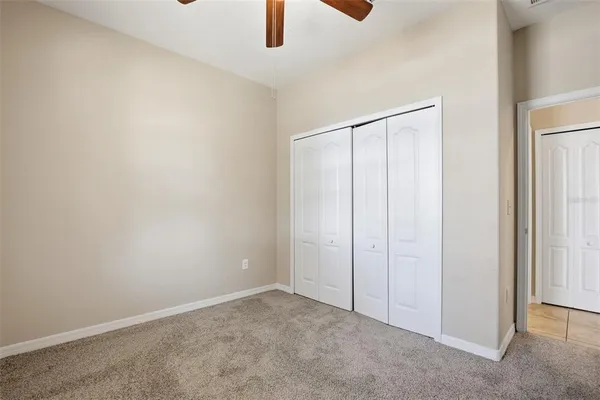 an empty room with a ceiling fan