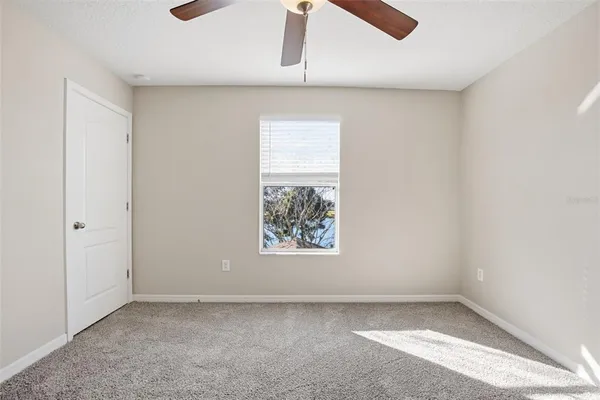 an empty room with closet and window